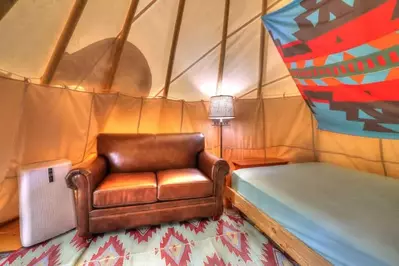 couch and bed inside tipi tent