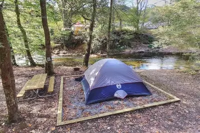 blue tent next to a river
