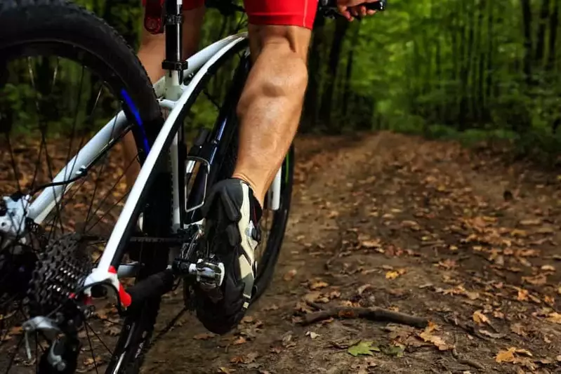 guy riding a bike in the woods