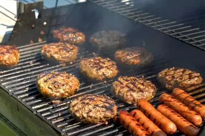 hot dogs and hamburgers on grill