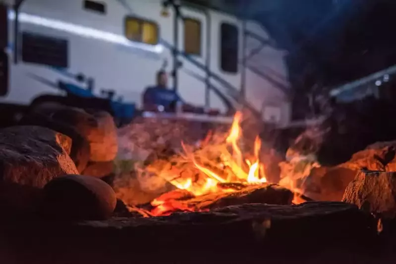campfire with rv in background
