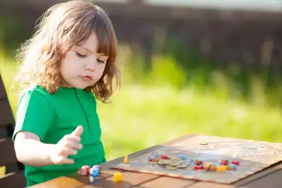 girl playing board game outside