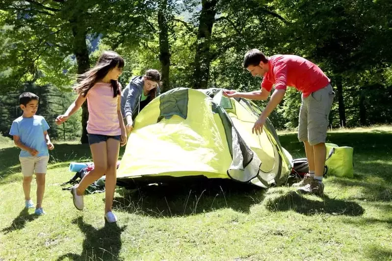 family setting up tent