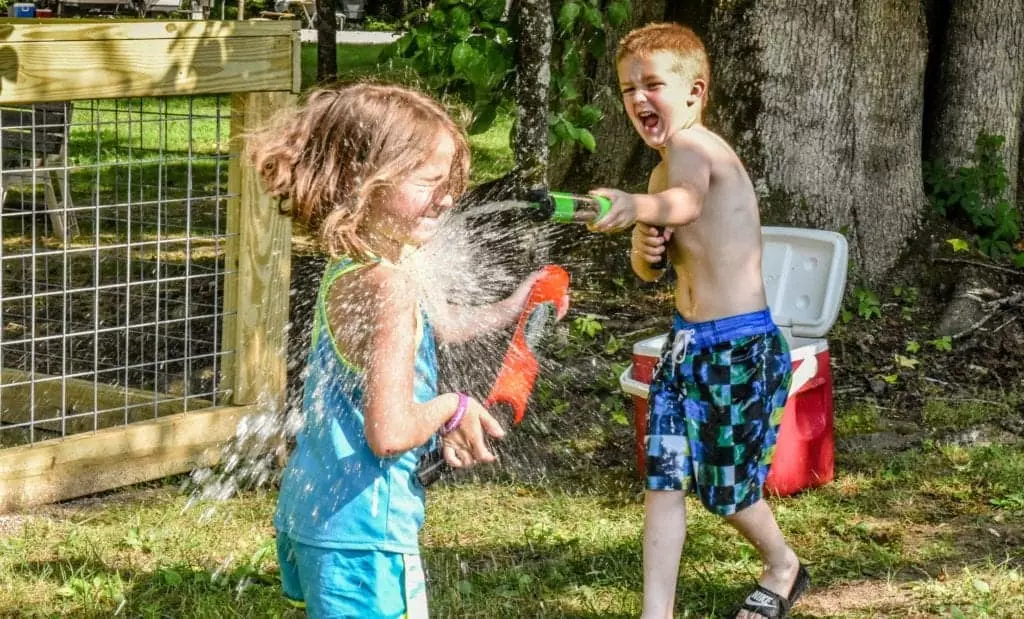 Two kids having a water fight