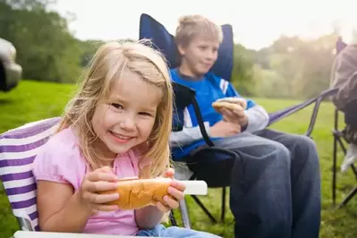 Girl with hot dog at campground in the Smoky Mountains