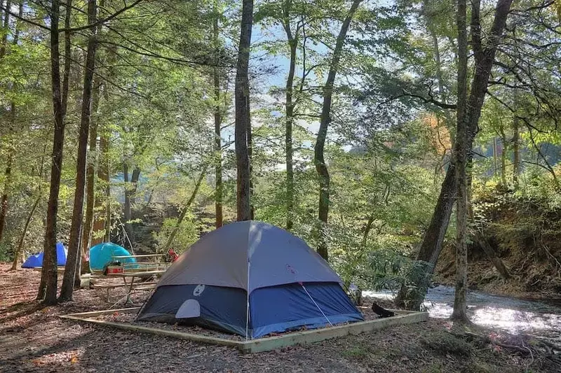 tent next to the river at a campground