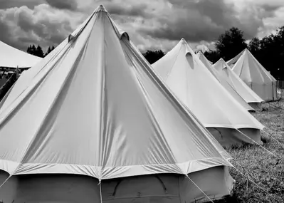 Black and white photo of camping tents.