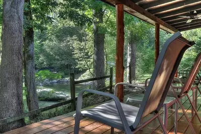 Chairs on the deck of the Flint Rock Cabin overlooking the Little Pigeon River.