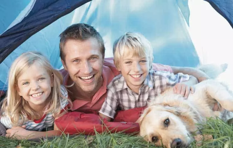 Father and two children enjoying Gatlinburg camping with the family dog