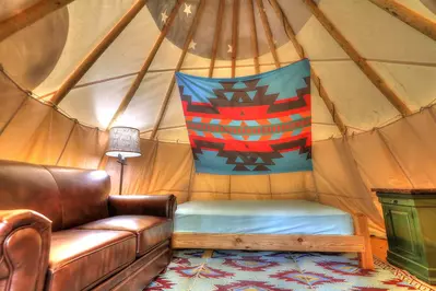 bed and couch in camping tent at a Smoky Mountain campground