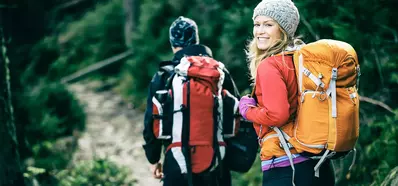 Two hikers on a camping adventure in the forest.