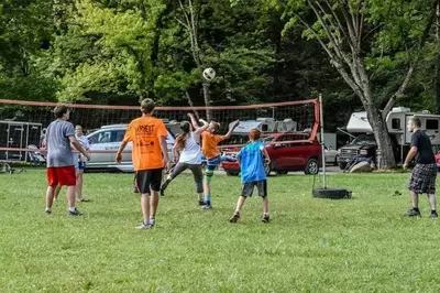 Family having fun playing volleyball at Greenbrier Campground