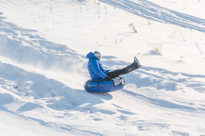 Boy snow tubing